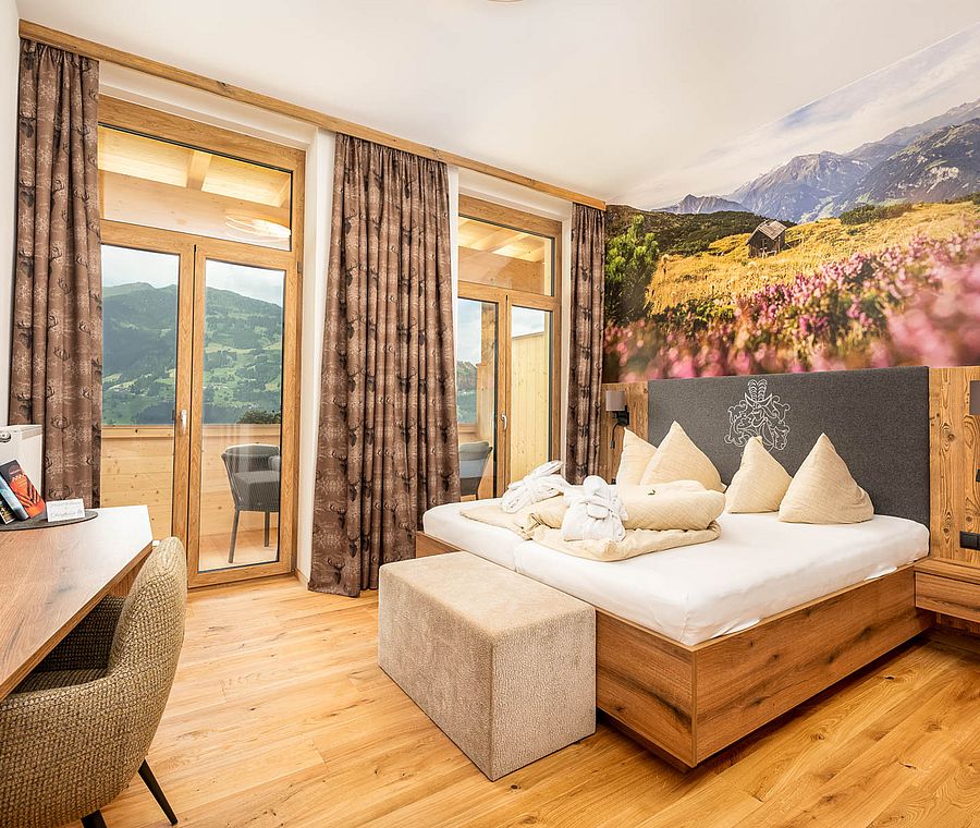 Cozy double room with wooden details, mountain wallpaper, desk and balcony with mountain view