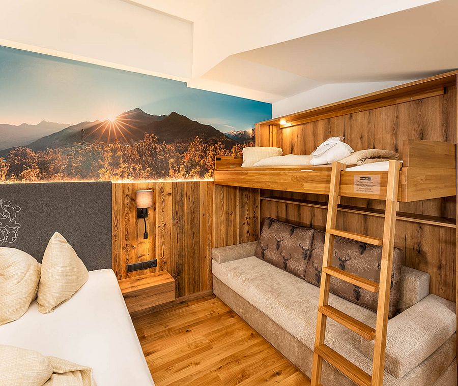 Family room with double bed, bunk bed, sofa and large mountain panorama mural